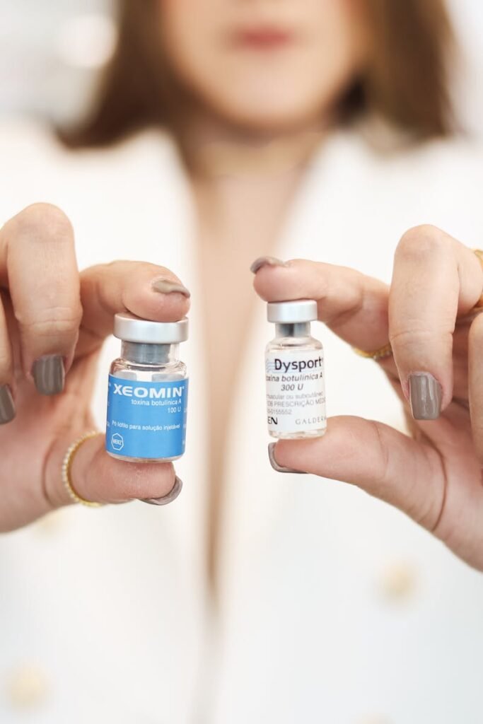 FAQ A close-up of a woman holding Xeomin and Dysport vials, showcasing cosmetic treatment options.